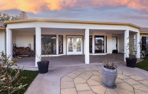 a view of a house with potted plants
