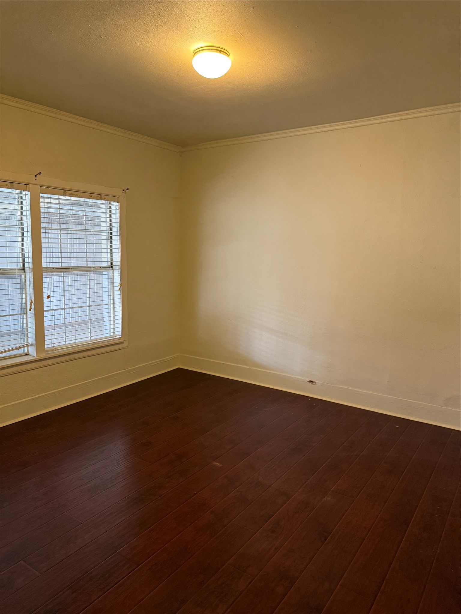 6318 Illinois Street Houston, TX 77021 - Photo 10 of 14 an empty room with wooden floor and windows