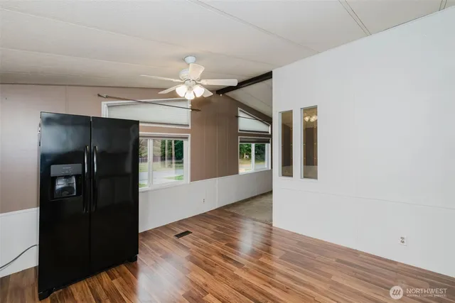 a kitchen with wooden floors and white appliances