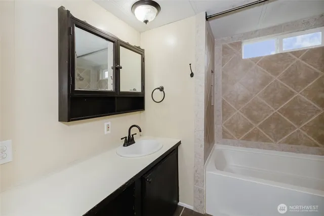 a bathroom with a bathtub and a shower