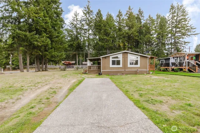 a house view with swimming pool and wooden fence