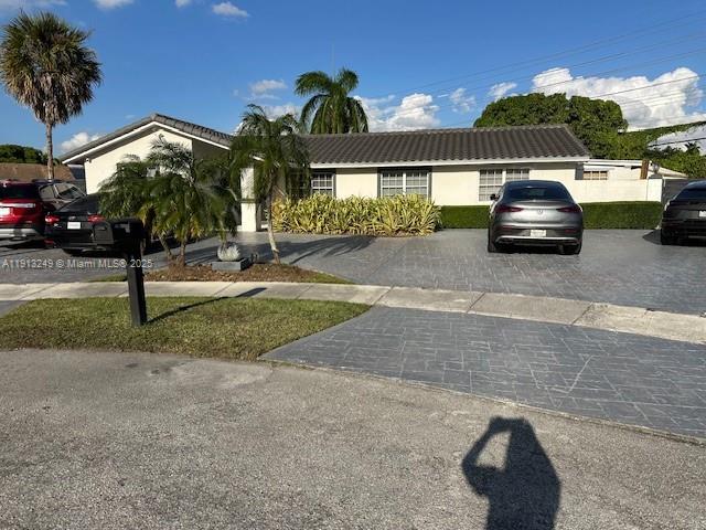 5531 Southwest 136th Court, Unit 1 Miami, FL 33175 - Photo 12 of 13 a front view of a house with a yard and garage