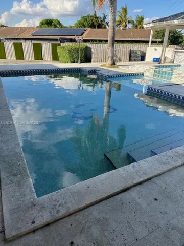 a view of swimming pool with outdoor seating