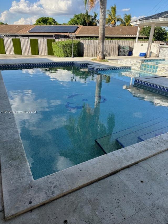5531 Southwest 136th Court, Unit 1 Miami, FL 33175 - Photo 3 of 13 a view of swimming pool with outdoor seating