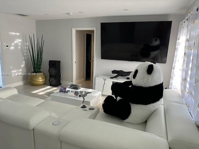 5531 Southwest 136th Court, Unit 1 Miami, FL 33175 - Photo 7 of 13 a living room with furniture and a flat screen tv