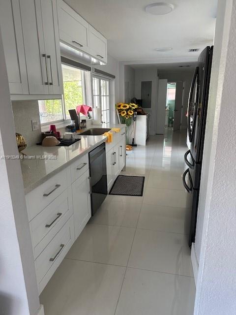 5531 Southwest 136th Court, Unit 1 Miami, FL 33175 - Photo 10 of 13 a kitchen with a refrigerator and a sink