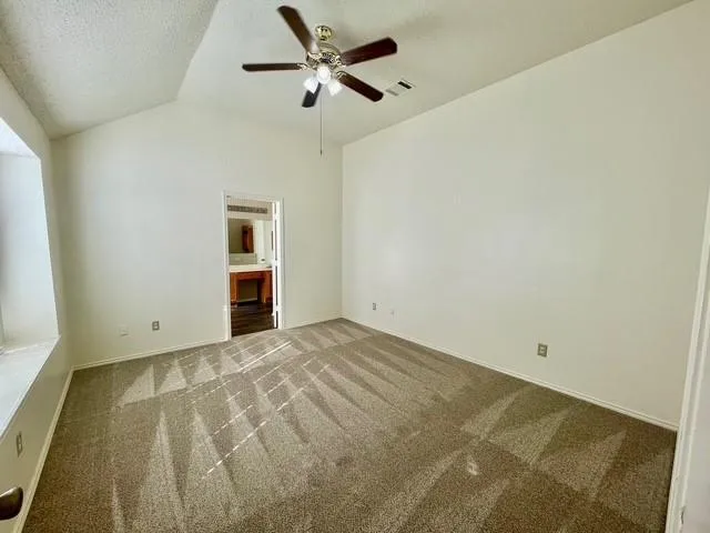 a view of empty room with ceiling fan