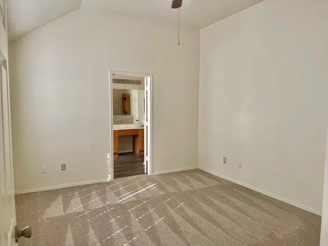 a view of an empty room with a fireplace and a window