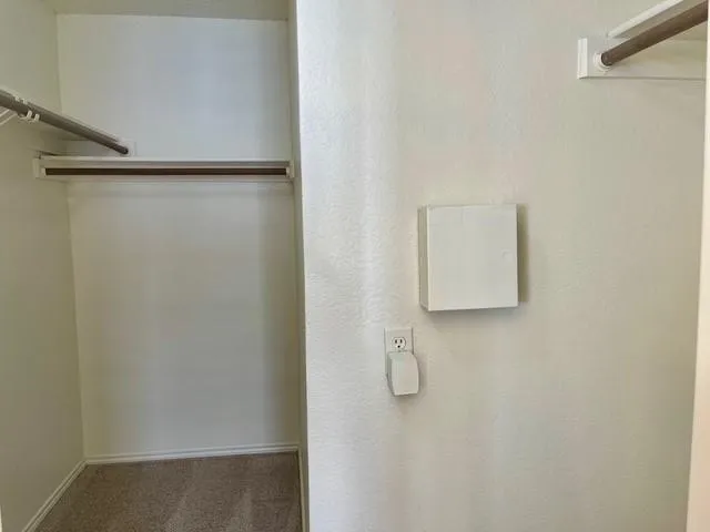 a view of staircase with wooden floor and white walls