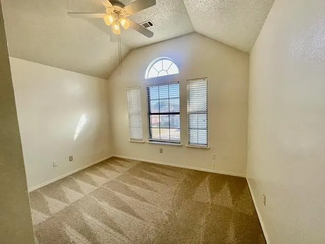 a bathroom with a sink a toilet a shower and a window