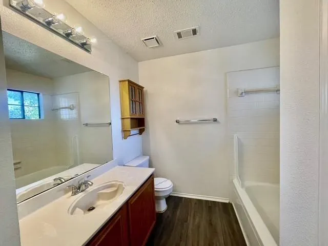 an empty room with a ceiling fan and carpet