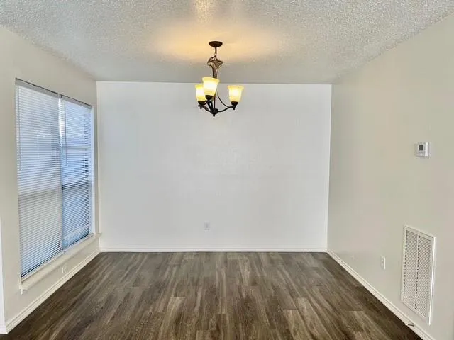 a view of kitchen and wooden floor