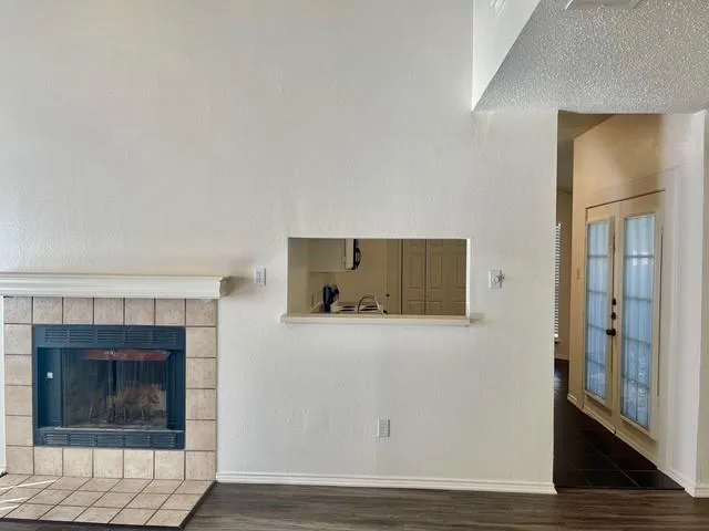 a room with wooden floor and a fireplace