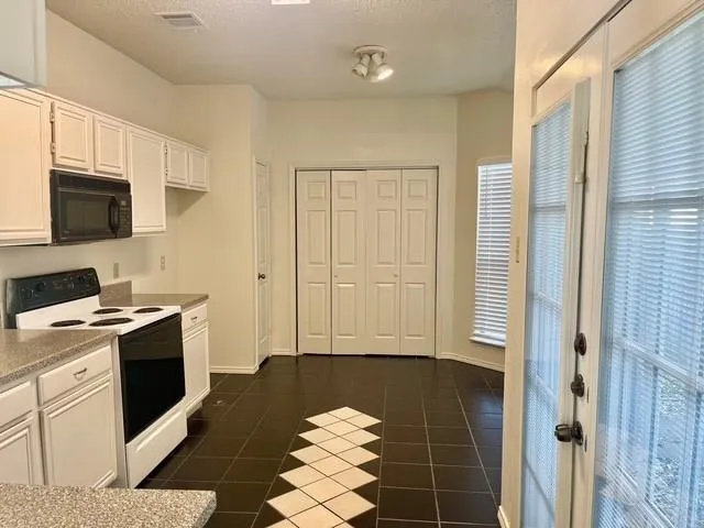 a kitchen with a sink cabinets and appliances