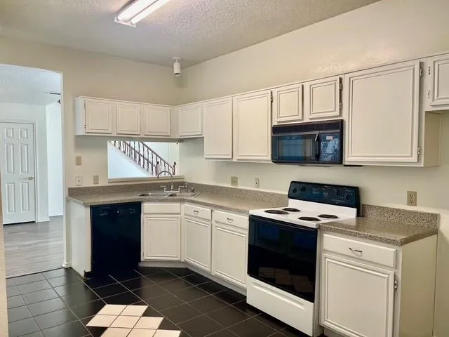 a kitchen with stainless steel appliances a stove microwave and cabinets