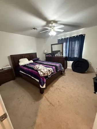 a bedroom with bed and window