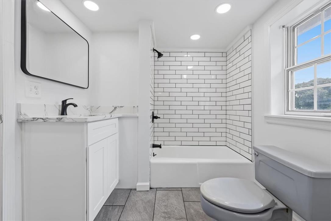 2412 Clearview Road Coplay, PA 18037 - Photo 27 of 53 A crisp tile surround and stone-look flooring anchor this updated washroom space.