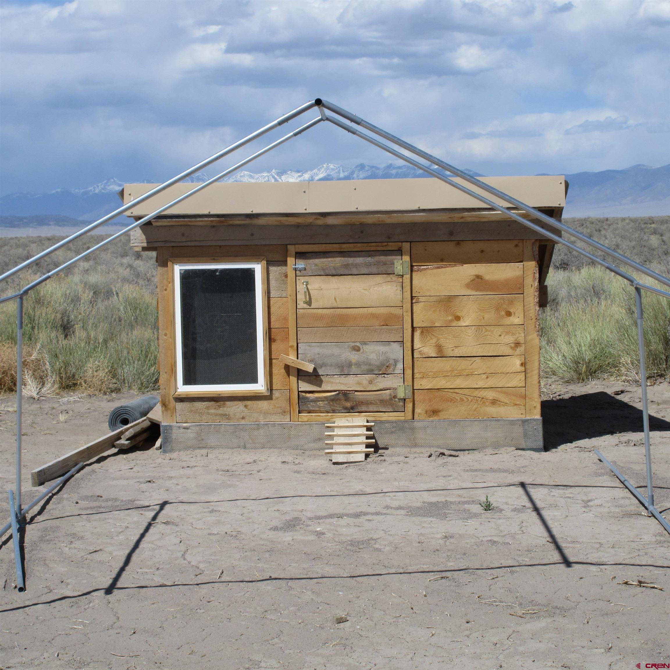 56063 County Road Saguache, CO 81149 - Photo 17 of 21 a view of a house with a outdoor space