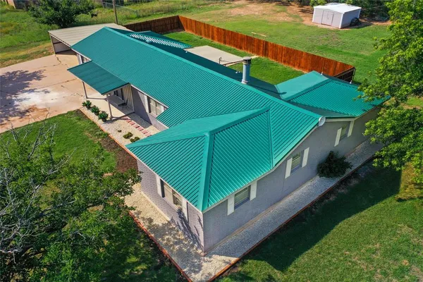 a view of a backyard with a small deck and a garden
