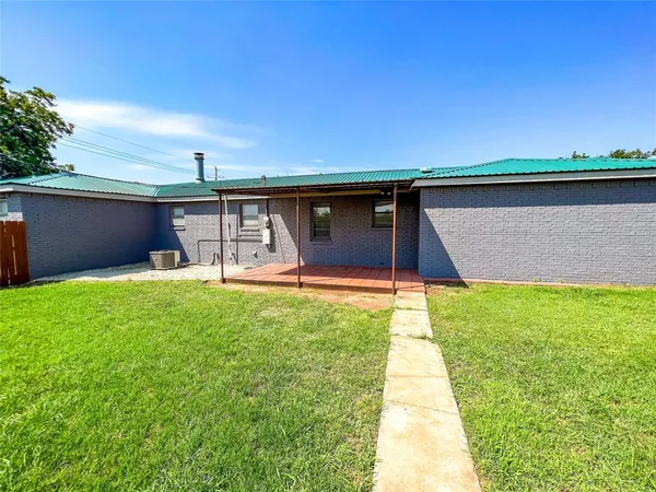 a view of backyard with tub and wooden fence