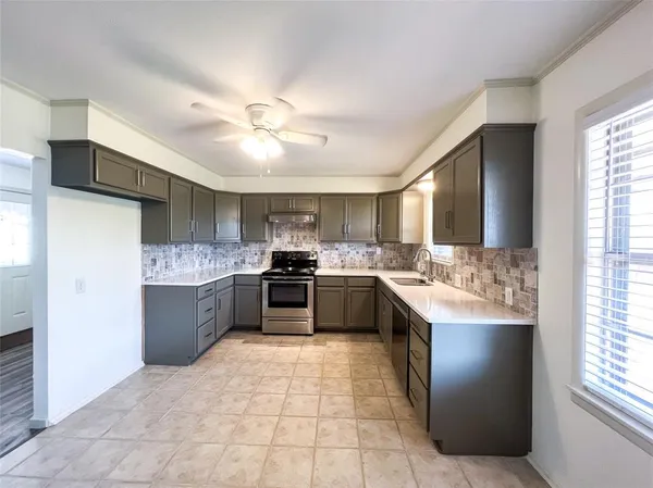 a large kitchen with a stove and a sink