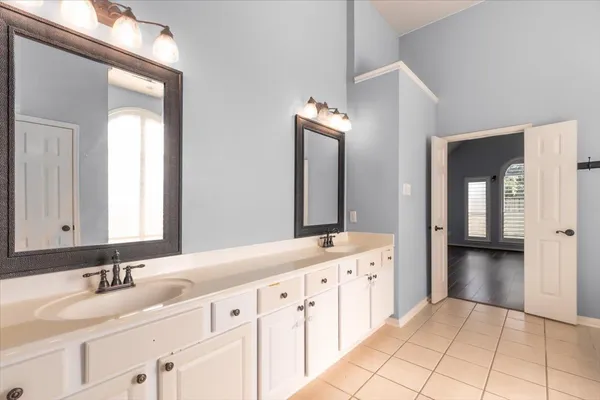 a bathroom with a double vanity sink and mirror
