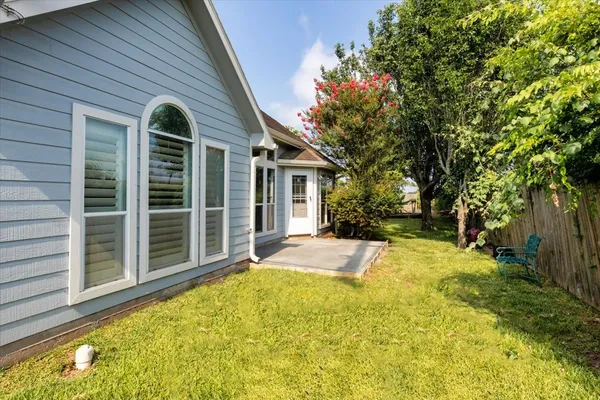 a view of a house with backyard and porch
