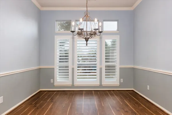 a view of a room with wooden floor and a window