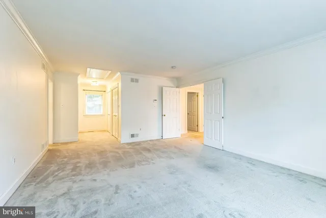 a view of an empty room and a window