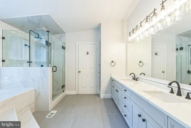 a spacious bathroom with a double vanity sink mirror double and shower