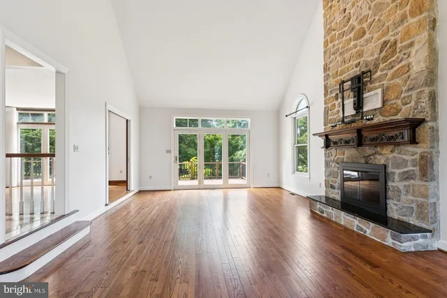 a view of a livingroom with wooden floor and a fireplace