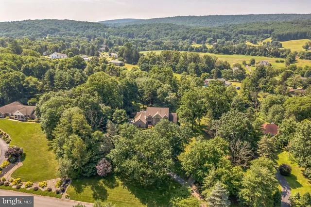 an aerial view of house with yard and mountain view