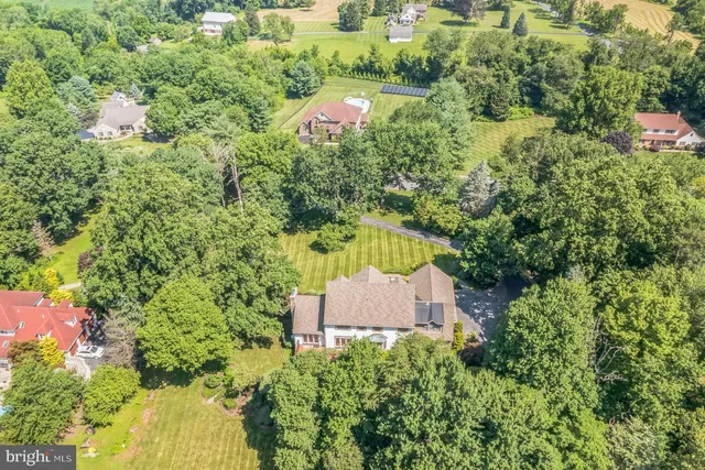 an aerial view of a house with a yard and lake view