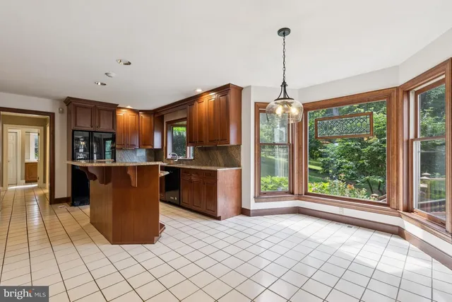 a kitchen with stainless steel appliances granite countertop a refrigerator a sink and dishwasher