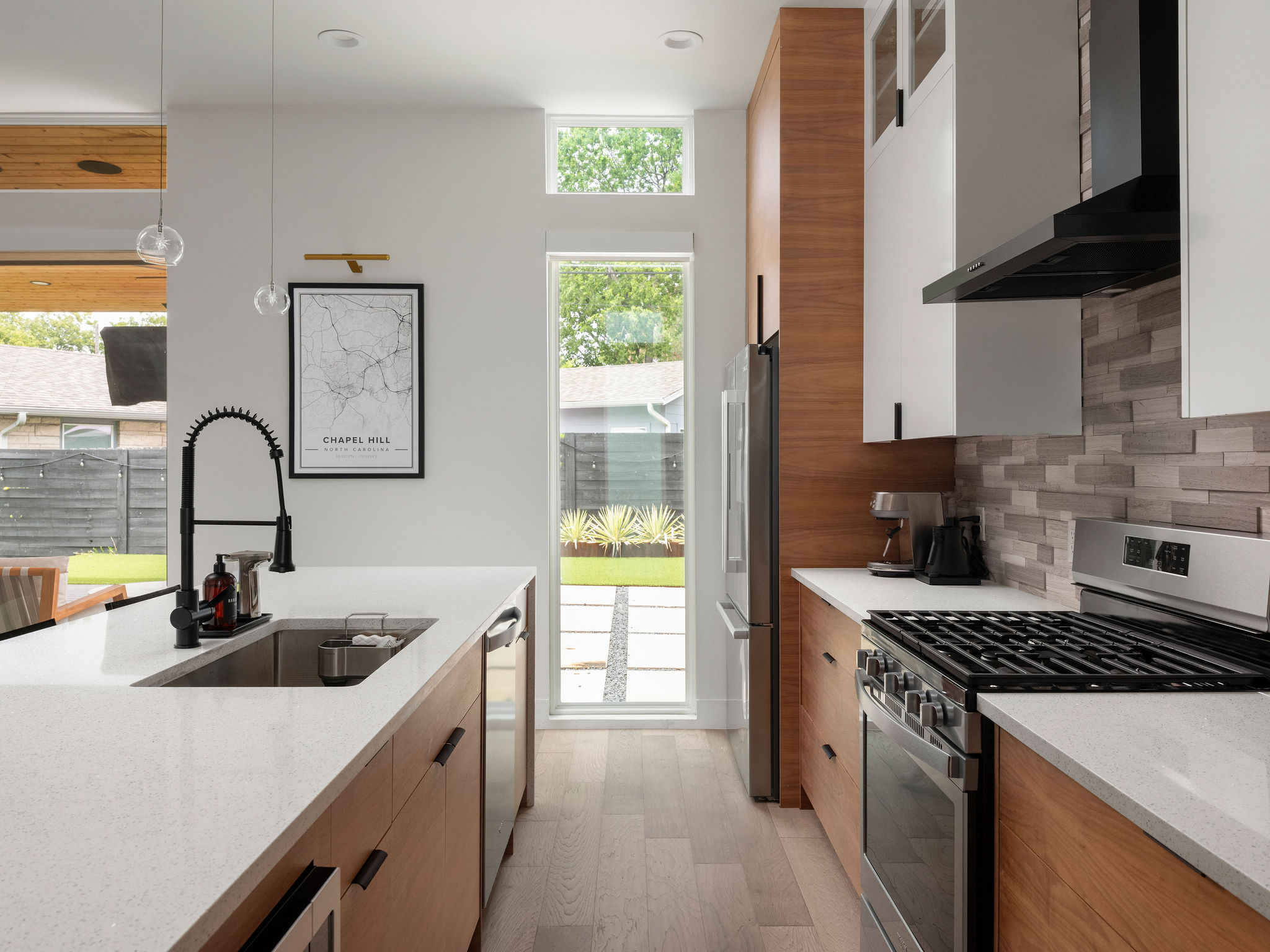 3710 Manorwood Road Austin, TX 78723 - Photo 15 of 40 Clean lines and a functional layout define this modern kitchen with ample counter space and natural light.