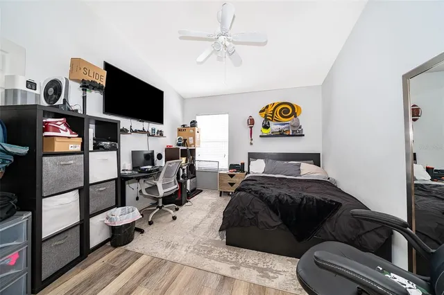 a bedroom with a bed and wooden floor