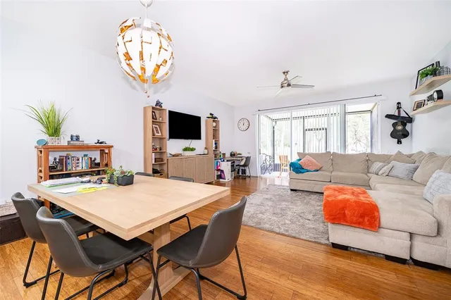 a living room with furniture a chandelier and a flat screen tv
