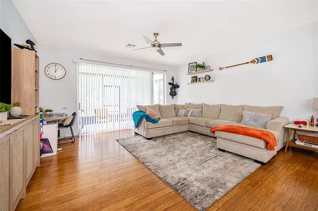 a living room with furniture and wooden floor
