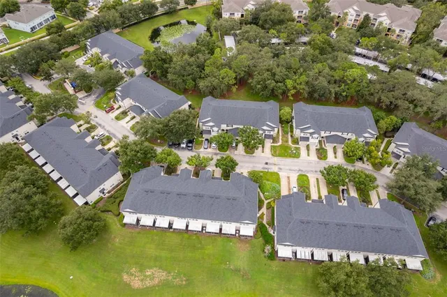 an aerial view of multiple houses with yard