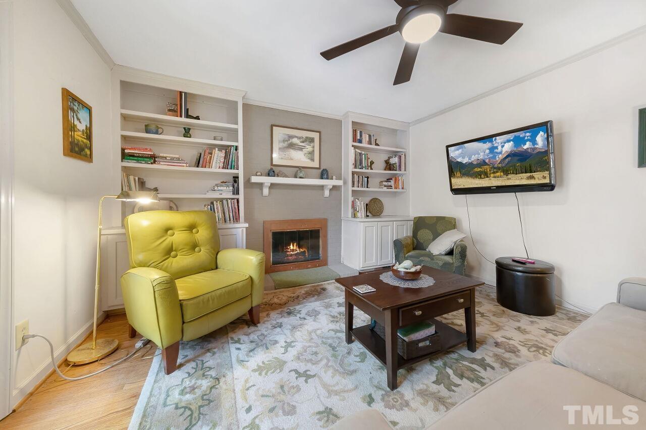 608 Brighton Road Durham, NC 27707 - Photo 12 of 26 a living room with furniture a flat screen tv and a fireplace