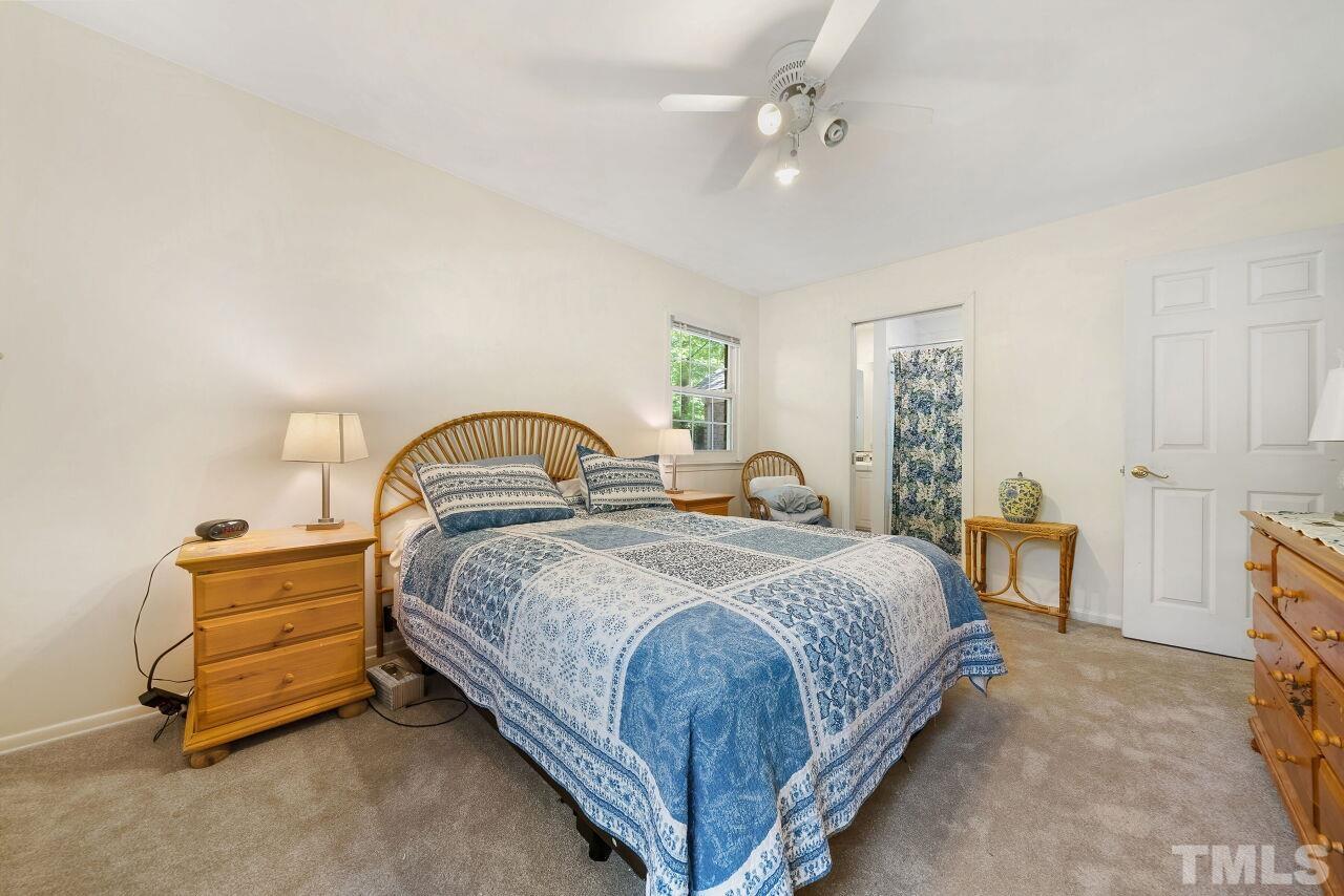 608 Brighton Road Durham, NC 27707 - Photo 14 of 26 a bedroom with a bed and a table