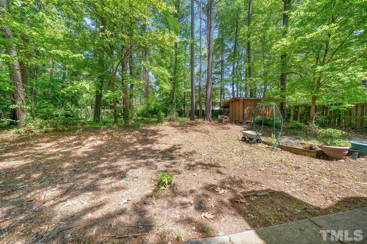 608 Brighton Road Durham, NC 27707 - Photo 20 of 26 a backyard of a house with barbeque oven and outdoor seating