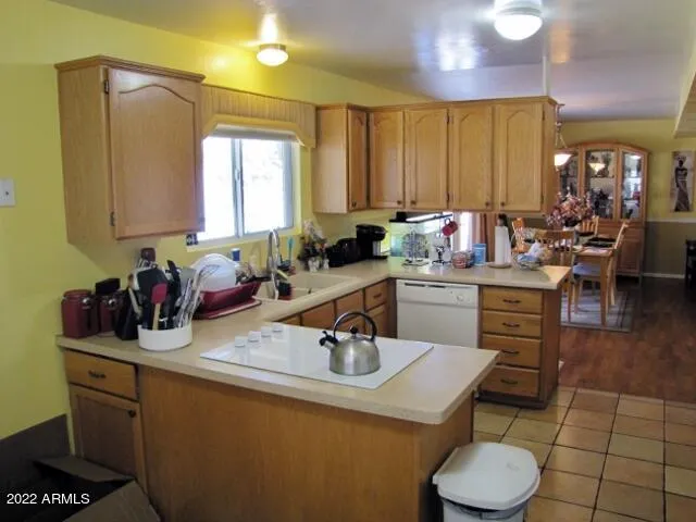 a kitchen with a sink a stove and cabinets