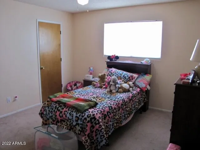 a living room with furniture a baby crib and a window