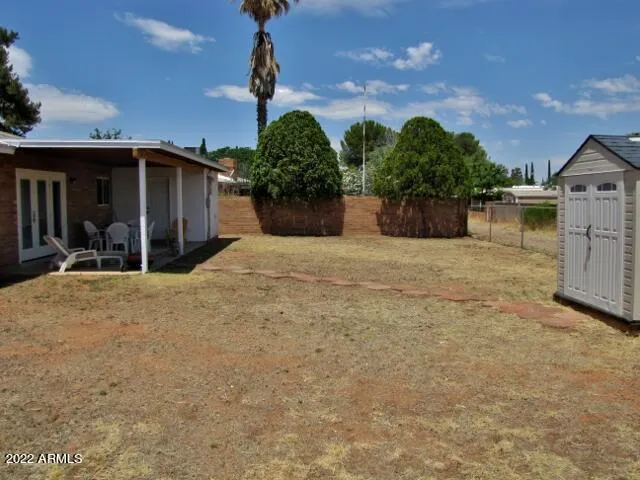 a front view of a house with a yard and potted plants