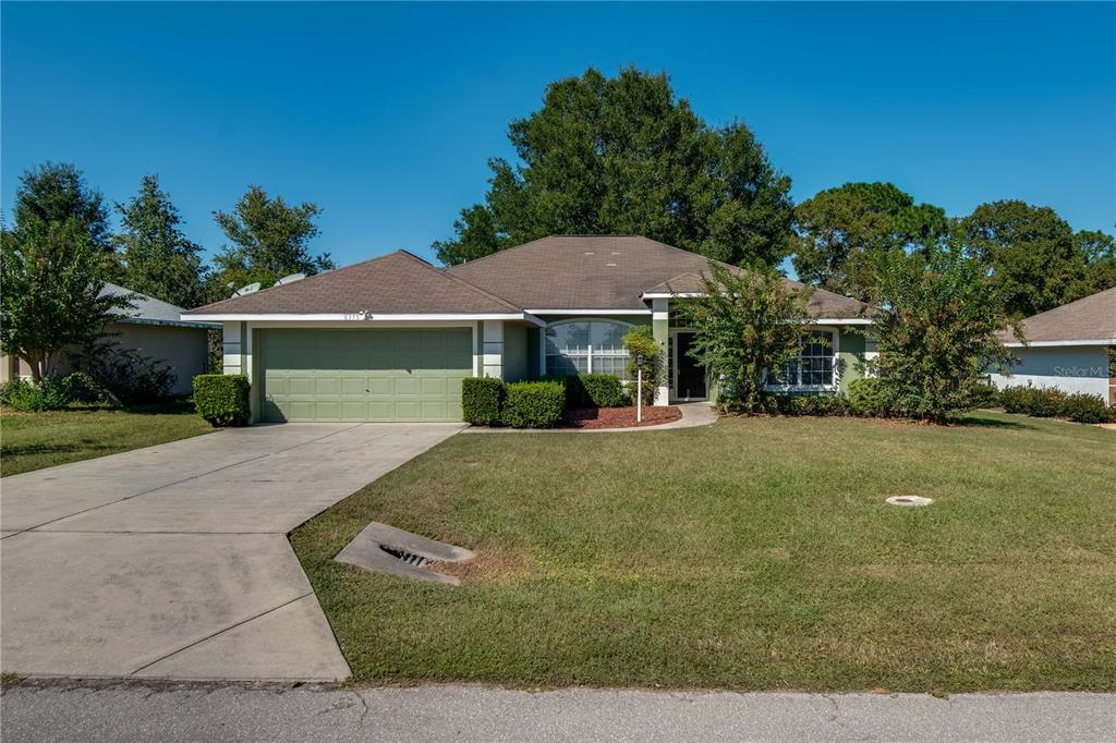 6375 Southwest 63rd Street Ocala, FL 34474 - Photo 2 of 35 a front view of a house with garden