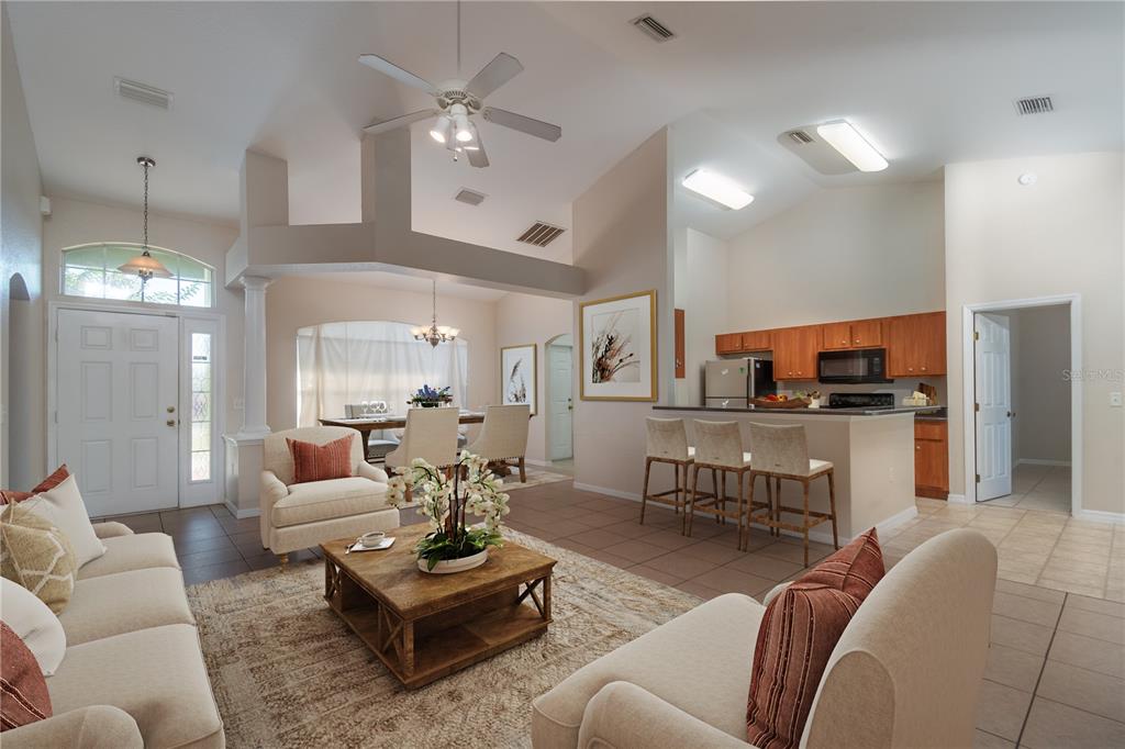 6375 Southwest 63rd Street Ocala, FL 34474 - Photo 5 of 35 a living room with furniture kitchen view and a chandelier