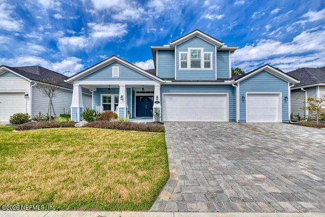 a view of living room with furniture and a chandelier