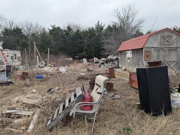 a view of a chairs and fire pit in the backyard