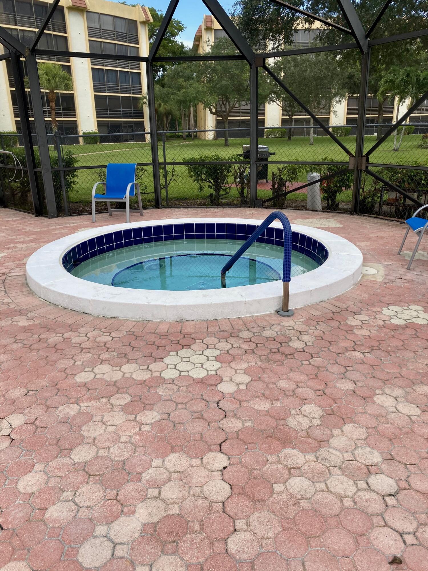 9170 Southwest 14th Street, Unit 4405 Boca Raton, FL 33428 - Photo 40 of 48 a view of pool with a table and chairs